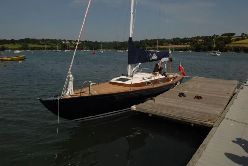 Slide: The Image of Sleek 2025 Rustler 33 sailboat docked on a sunny day. - 7