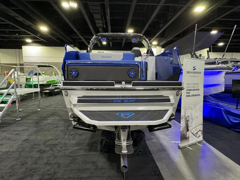 Slide: The Image of Paradigm 236 boat displayed at an indoor exhibition, showcasing sleek design and advanced features. - 3
