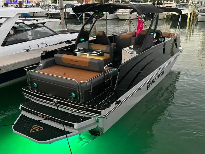 The Image of 2025 Paradigm Damascus 260 Surf boat with sleek design and green underwater lights. - 0