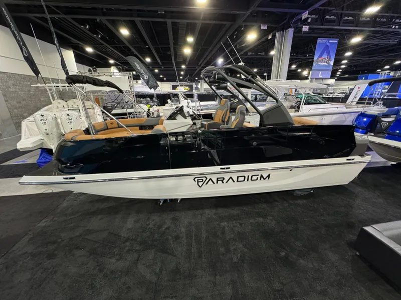 Slide: The Image of 2025 Paradigm Damascus 260 Surf boat displayed at an indoor boat show. - 2