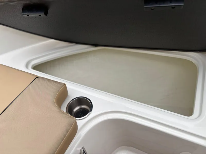 Slide: The Image of 2023 Bayliner VR4 boat interior with storage compartment and cup holder. - 13