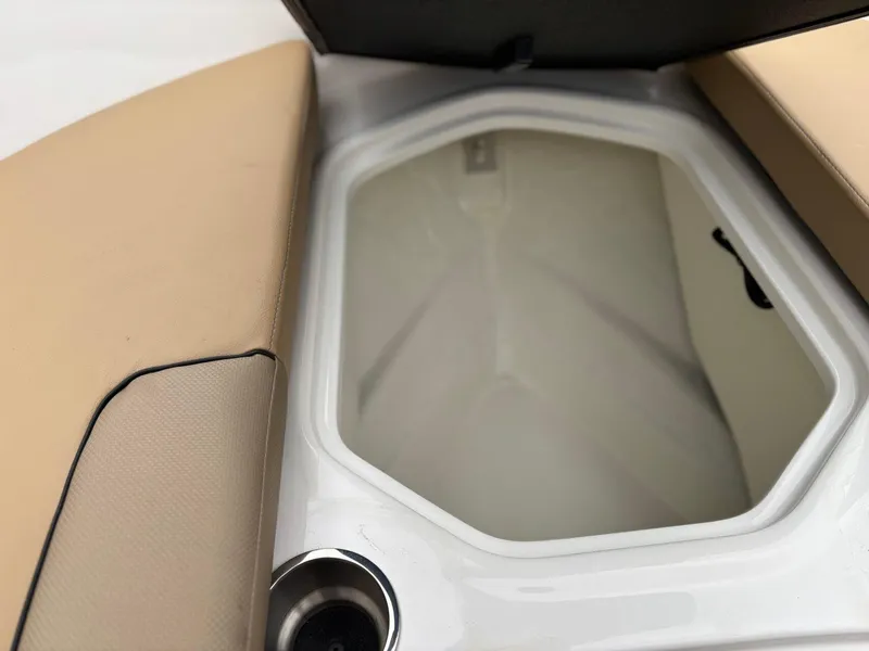 Slide: The Image of Open storage compartment on 2023 Bayliner VR4 boat with beige seating. - 14