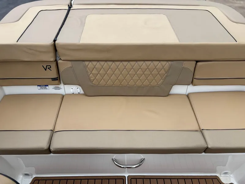 Slide: The Image of 2023 Bayliner VR4 boat with tan cushioned seating and diamond-patterned backrest. - 7