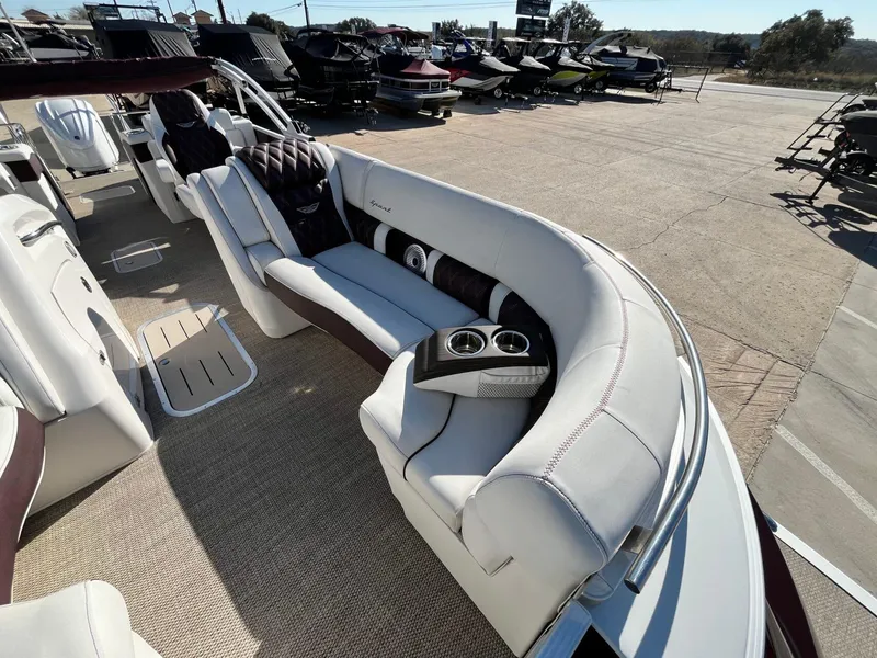 Slide: The Image of 2023 Bennington 23Q pontoon boat interior with luxurious seating and cup holders. - 12