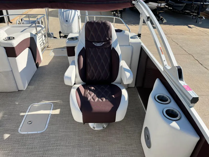 Slide: The Image of 2023 Bennington 23Q boat interior with luxurious captain's chair and cup holders. - 16