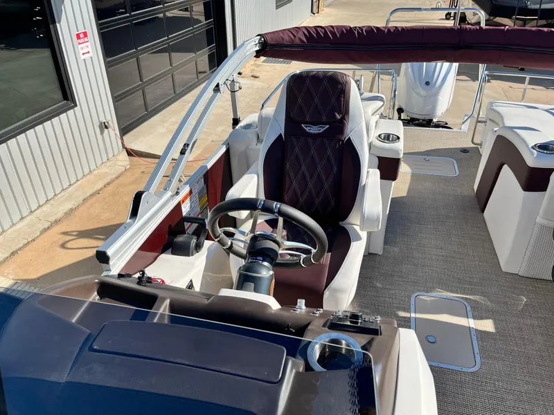 Slide: The Image of 2023 Bennington 23Q boat interior with steering wheel and seating, showcasing luxury design. - 17