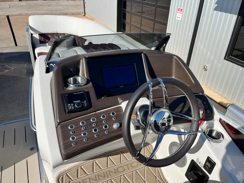 Slide: The Image of 2023 Bennington 23Q boat dashboard with steering wheel and control panel. - 18