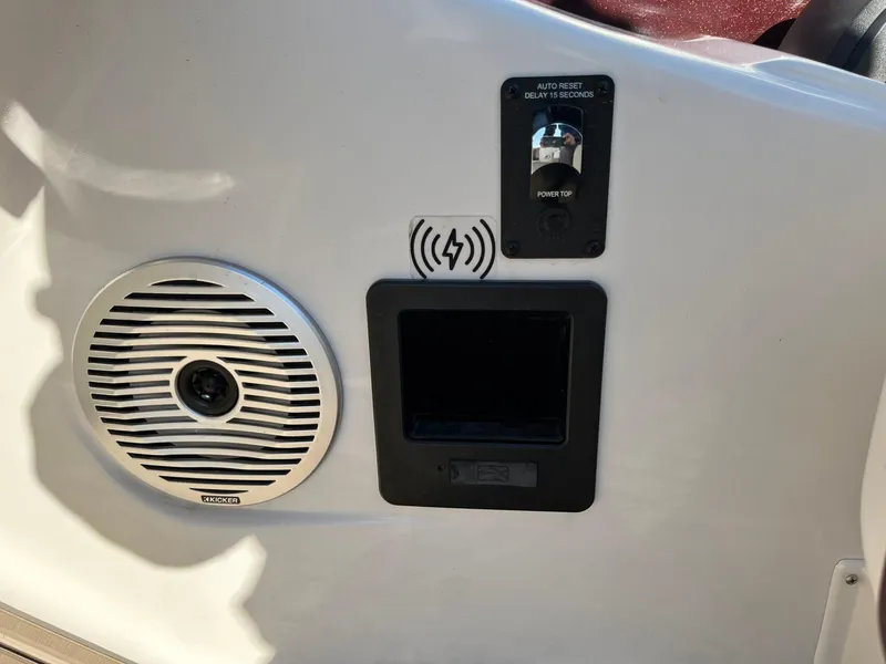 Slide: The Image of 2023 Bennington 23Q boat panel with speaker, power switch, and wireless charging pad. - 21