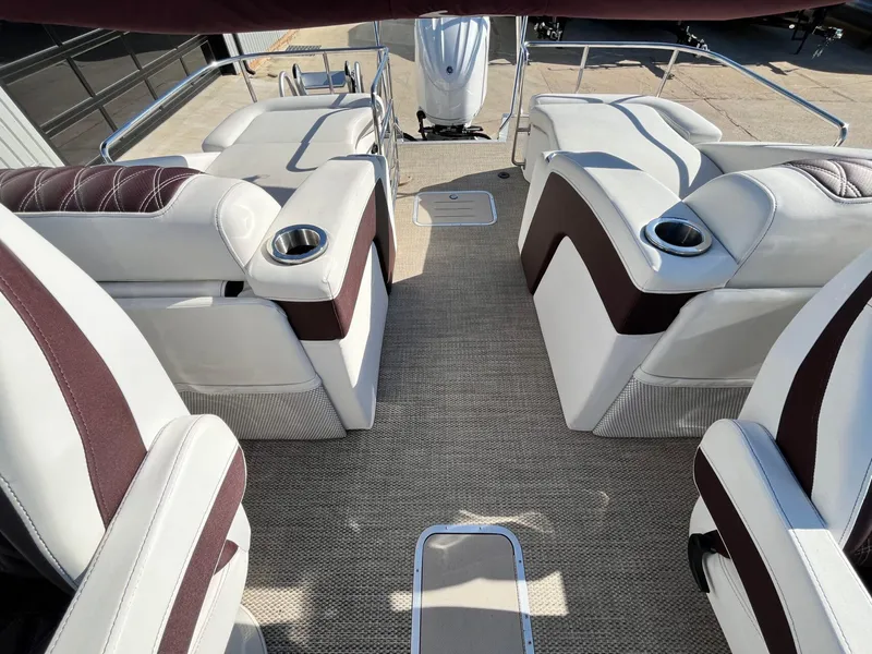 Slide: The Image of 2023 Bennington 23Q boat interior with plush seating and cup holders. - 25