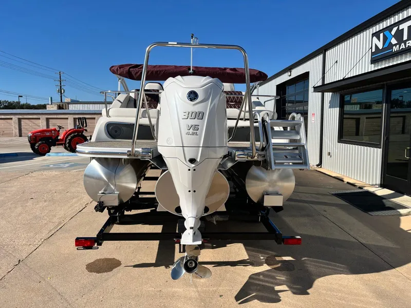 Slide: The Image of 2023 Bennington 23Q pontoon boat with Yamaha 300 V6 engine, parked outside dealership. - 3