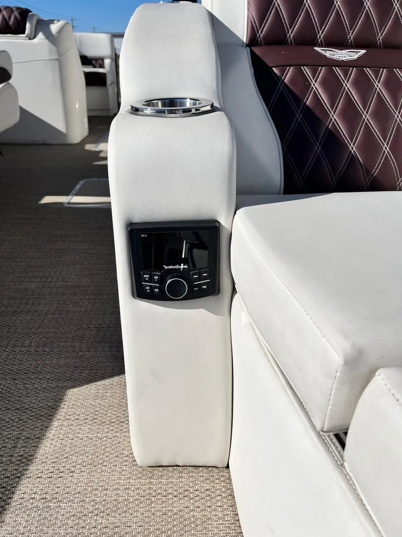 Slide: The Image of 2023 Bennington 23Q boat interior with plush seating and integrated audio controls. - 30