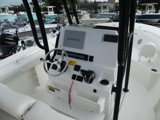 Slide: The Image of 2025 Key West 244 CC boat with white cushioned seating and Yamaha engines. - 14