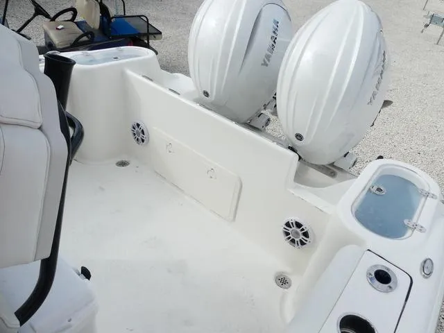 Slide: The Image of 2025 Key West 244 CC boat interior with rod holders and cooler storage. - 18