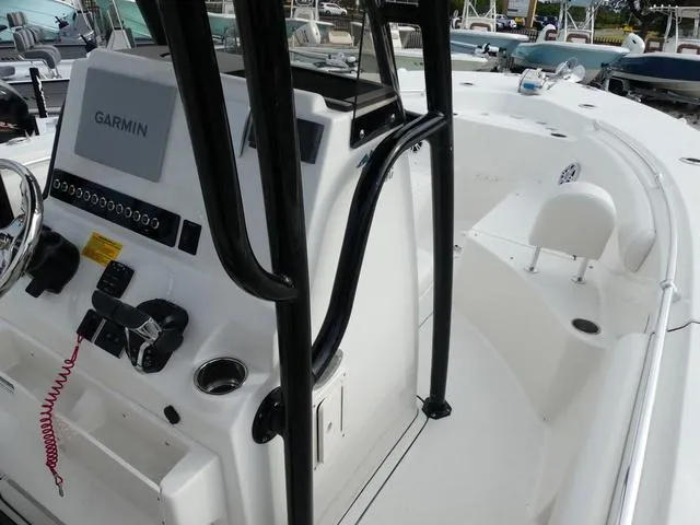 Slide: The Image of 2025 Key West 244 CC boat interior with white seating and storage compartments. - 23