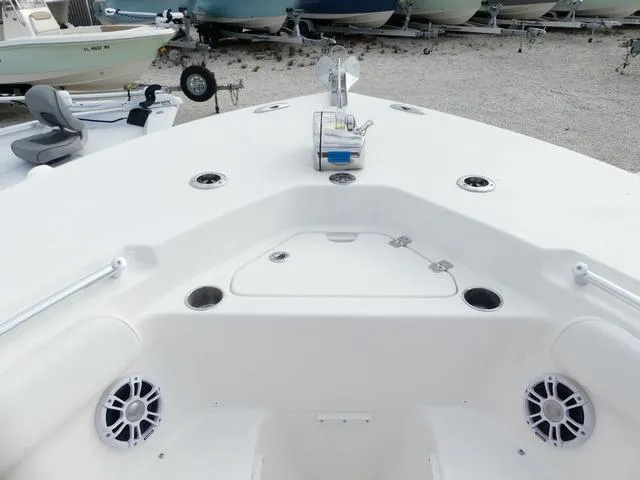 Slide: The Image of 2025 Key West 244 CC boat interior with white seating and spacious layout. - 27