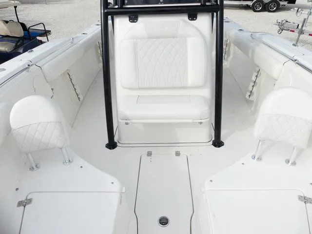 Slide: The Image of 2025 Key West 244 CC boat with T-top and seating, docked in a marina. - 28