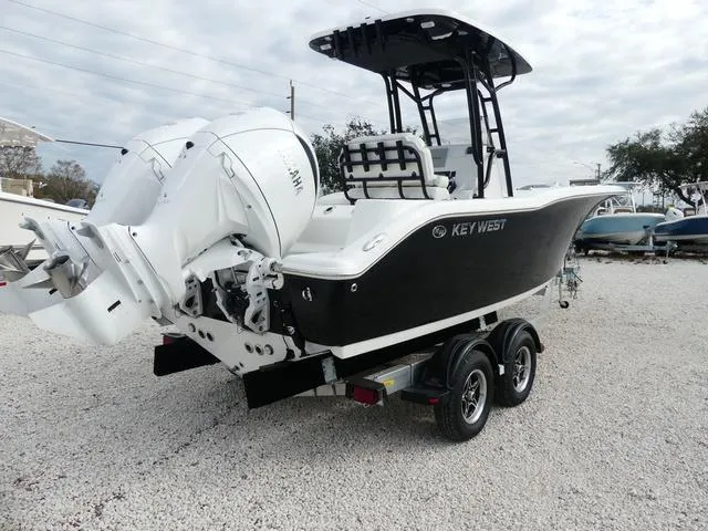 Slide: The Image of 2025 Key West 244 CC boat with dual outboard engines, rear view. - 5