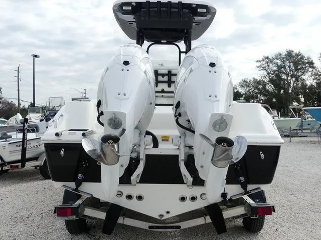 Slide: The Image of 2025 Key West 244 CC boat on trailer, dual engines, parked on gravel lot. - 6