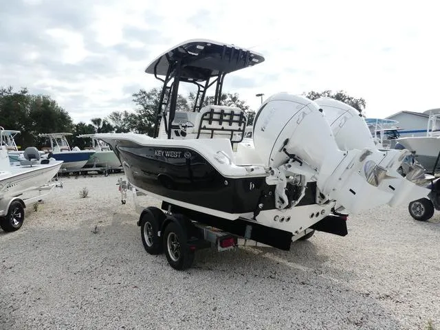 Slide: The Image of 2025 Key West 244 CC boat on trailer, black hull, outdoor display. - 7