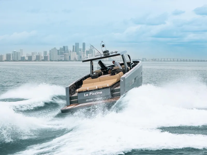 Slide: The Image of Fjord 52 Open yacht cruising near city skyline, 2022 model. - 2