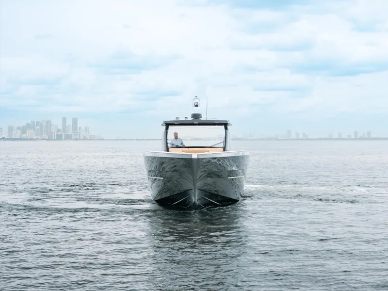 Slide: The Image of 2022 Fjord 52 Open yacht cruising on open water with city skyline in background. - 3