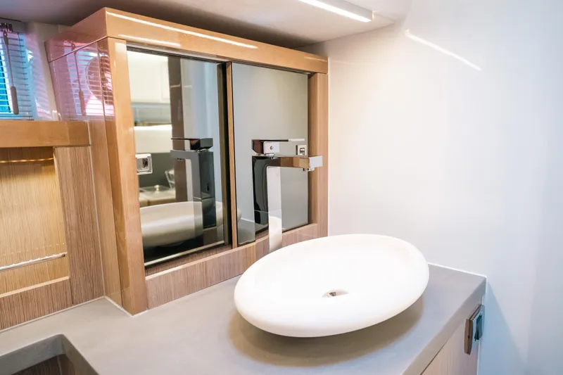 Slide: The Image of Modern bathroom vanity in 2022 Fjord 52 Open yacht with sleek sink and mirrored cabinets. - 38