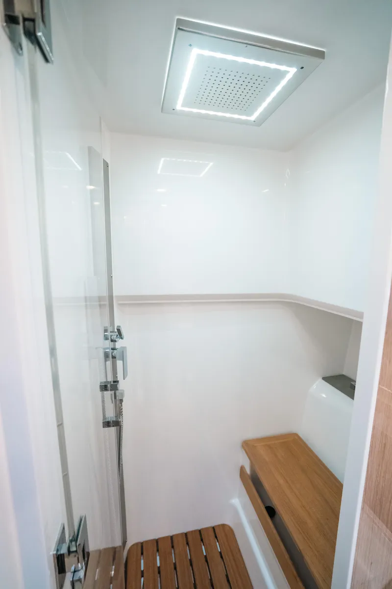 Slide: The Image of 2022 Fjord 52 Open yacht interior shower with wooden bench and modern fixtures. - 43