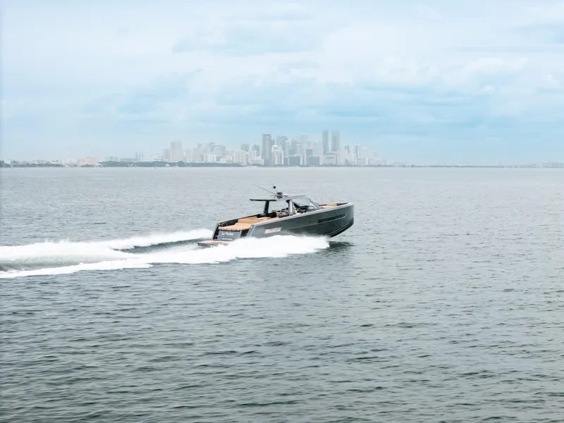 Slide: The Image of 2022 Fjord 52 Open yacht cruising on open water with city skyline in background. - 46