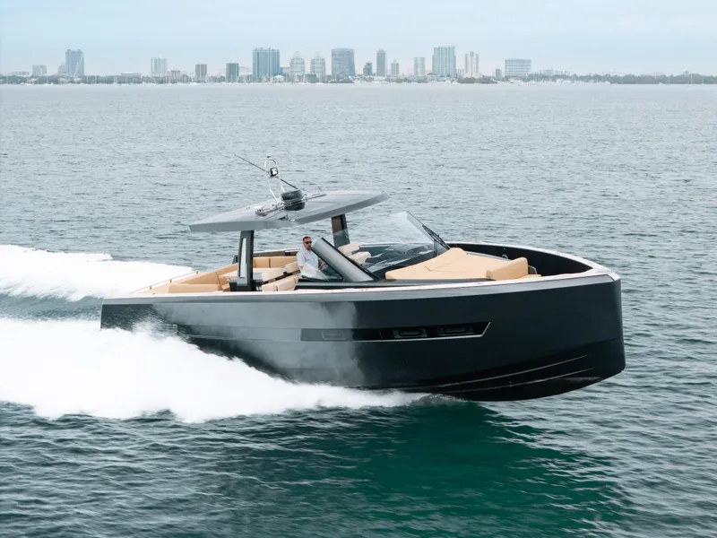 Slide: The Image of 2022 Fjord 52 Open yacht cruising on the ocean with city skyline in background. - 47