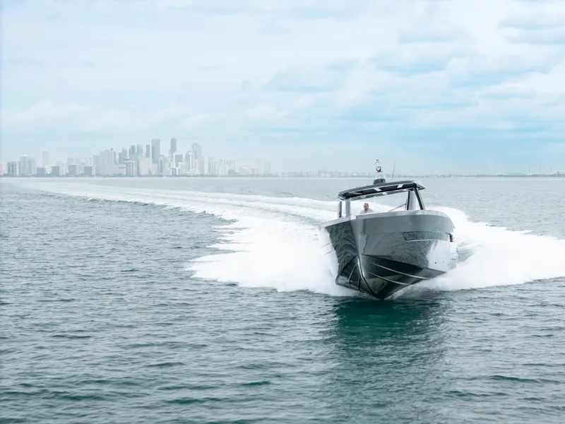 Slide: The Image of 2022 Fjord 52 Open yacht cruising on open water with city skyline in background. - 6