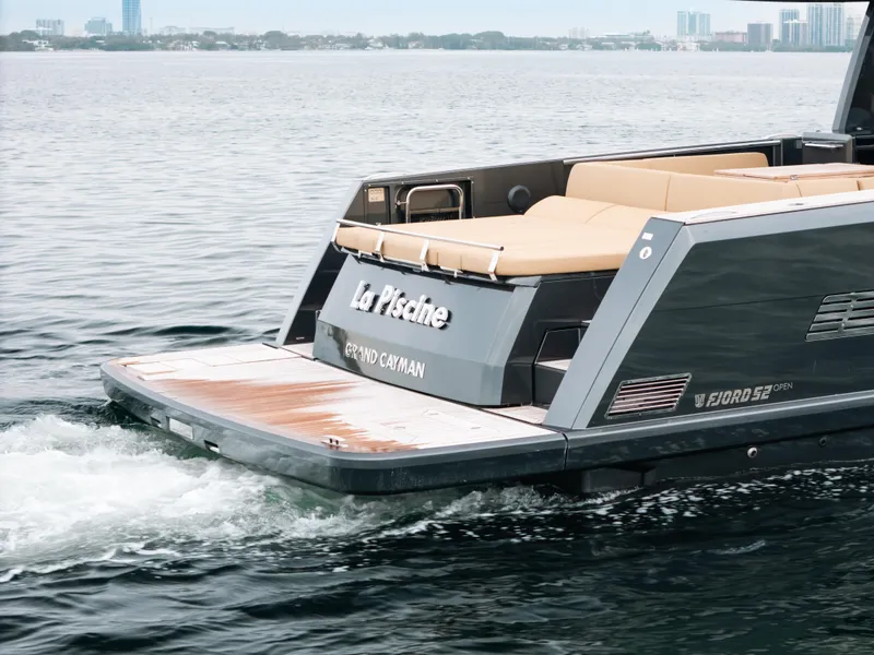 Slide: The Image of 2022 Fjord 52 Open yacht cruising on water with city skyline in background. - 9