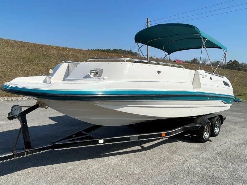 Slide: The Image of 1996 Chaparral Sunesta 250 boat on trailer with canopy, parked outdoors. - 16
