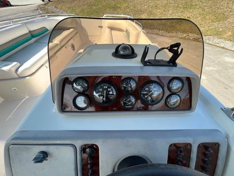Slide: The Image of 1996 Chaparral Sunesta 250 boat dashboard with gauges and seating area. - 25