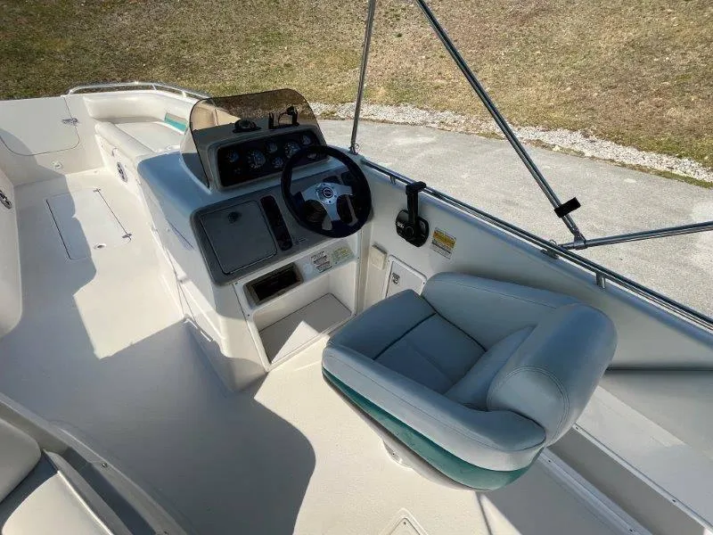 Slide: The Image of 1996 Chaparral Sunesta 250 boat cockpit with steering wheel and seating. - 26