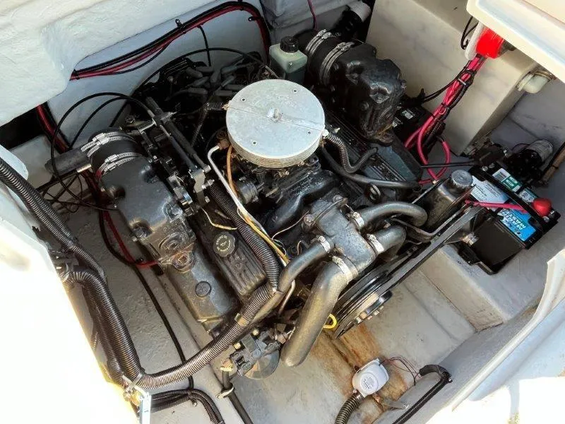 Slide: The Image of 1996 Chaparral Sunesta 250 engine compartment with visible wiring and battery. - 27