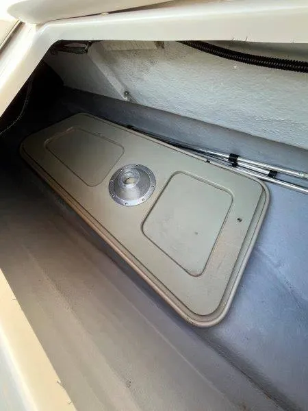 Slide: The Image of 1996 Chaparral Sunesta 250 storage compartment with hatch cover. - 28
