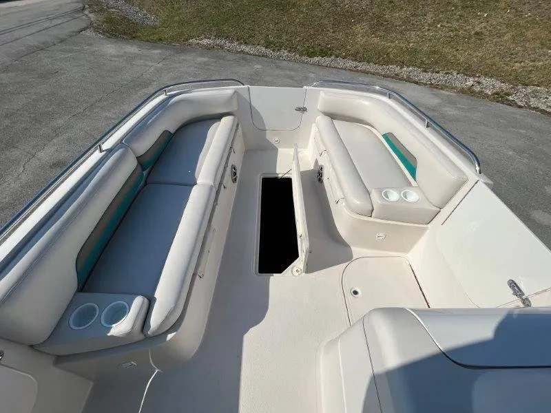 Slide: The Image of 1996 Chaparral Sunesta 250 boat interior with white seating and storage compartment. - 29