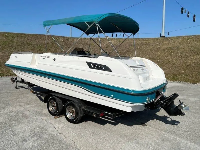 Slide: The Image of 1996 Chaparral Sunesta 250 boat on trailer with teal canopy. - 3