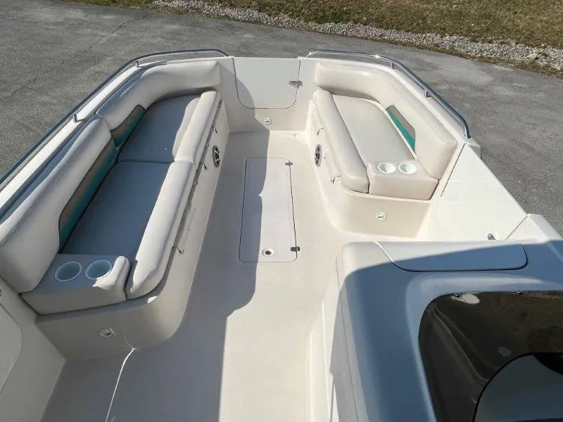 Slide: The Image of 1996 Chaparral Sunesta 250 boat interior with white seating and cup holders. - 33