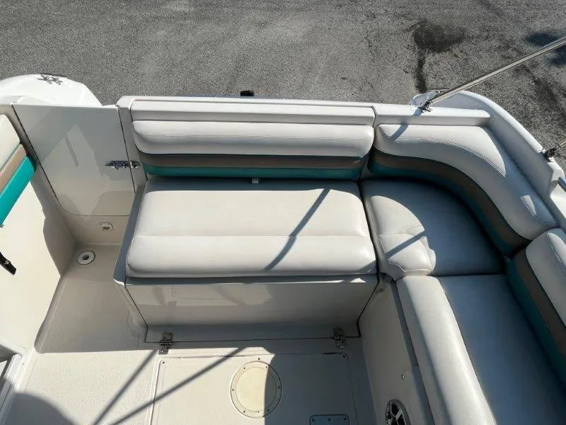 Slide: The Image of 1996 Chaparral Sunesta 250 boat interior with white cushioned seating. - 35