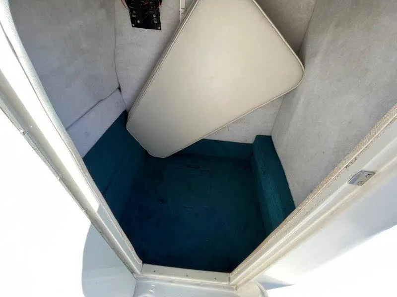 Slide: The Image of Interior cabin of 1996 Chaparral Sunesta 250 boat with blue carpet and cushion. - 36