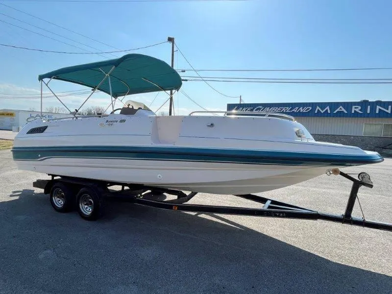 Slide: The Image of 1996 Chaparral Sunesta 250 boat on trailer with green canopy at marina. - 4