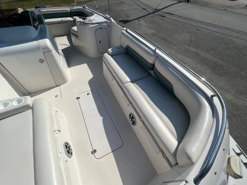 Slide: The Image of 1996 Chaparral Sunesta 250 boat interior with white seating and storage compartments. - 40