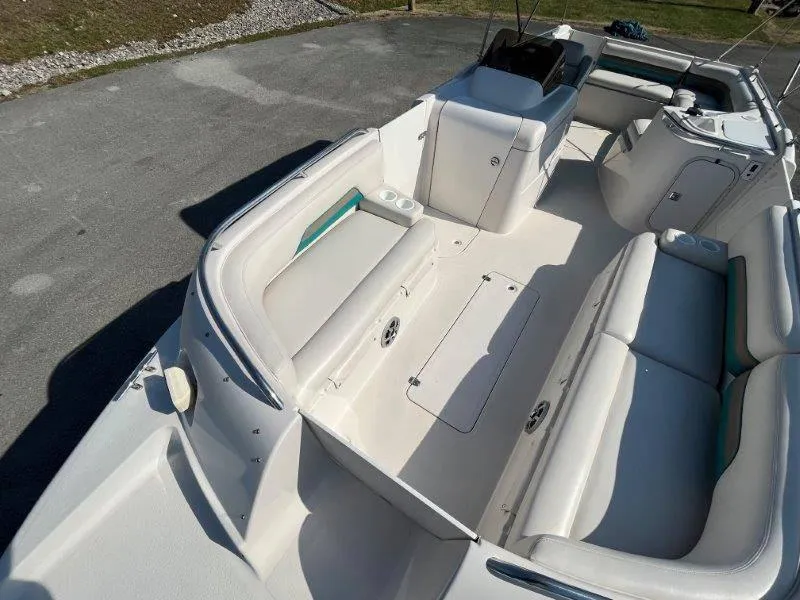 Slide: The Image of 1996 Chaparral Sunesta 250 boat interior with white seating and storage compartments. - 41