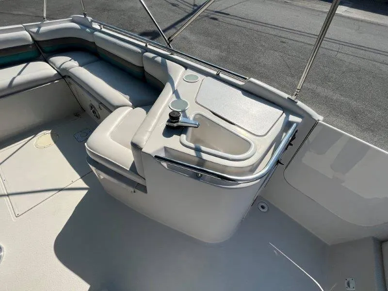 Slide: The Image of 1996 Chaparral Sunesta 250 boat interior with seating and sink. - 44