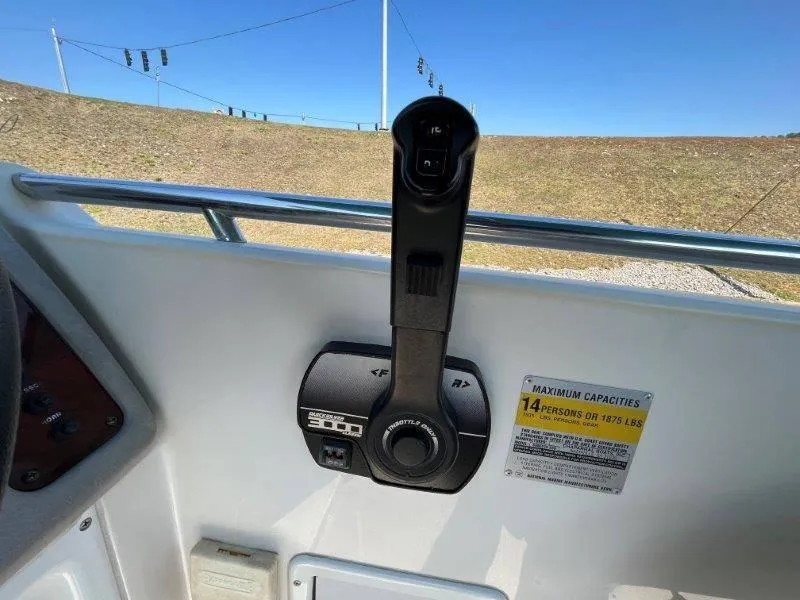 Slide: The Image of 1996 Chaparral Sunesta 250 boat throttle control and capacity label, 14 persons or 1875 lbs. - 49