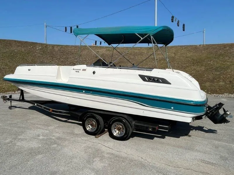 Slide: The Image of 1996 Chaparral Sunesta 250 boat on trailer with teal canopy. - 5