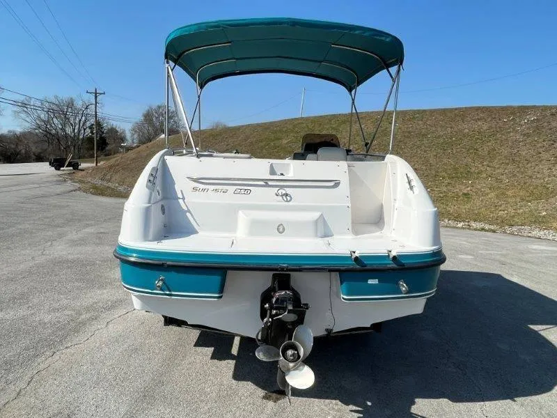 Slide: The Image of 1996 Chaparral Sunesta 250 boat with teal canopy, rear view. - 6