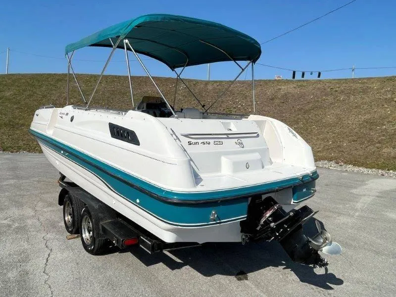 Slide: The Image of 1996 Chaparral Sunesta 250 boat with teal canopy on trailer. - 7