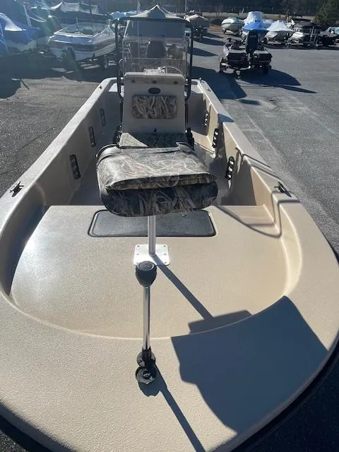 Slide: The Image of 2025 Carolina Skiff E20 JVX boat with seating, parked outdoors. - 3